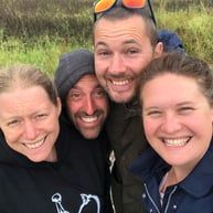 Mike, Steve and their wives smiling and taking a selfie style photo together