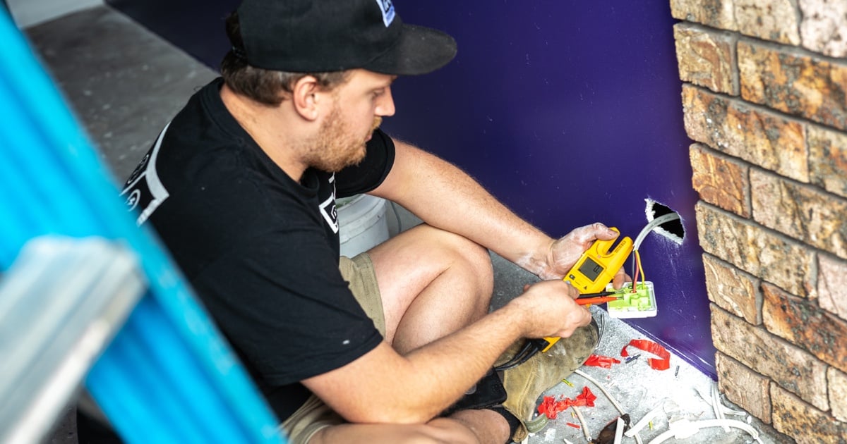 good electrician testing a socket