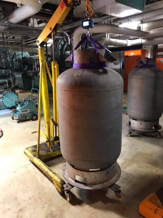 Photo of two large industrial gas tanks being wheeled into an installation