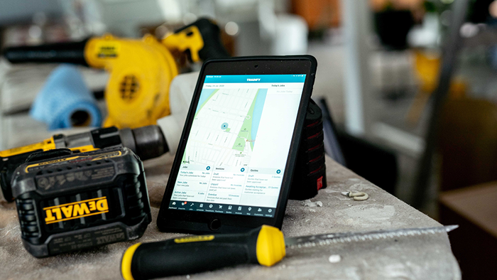 closeup of tablet showing map next to DeWALT drill and knife