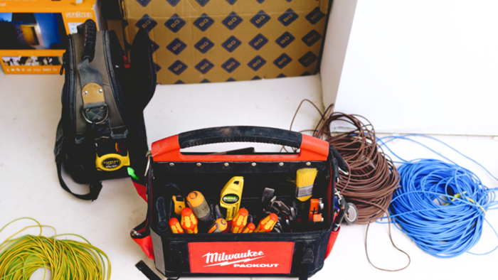 close up of electrical tools like wiring, screws, brushes and tape measure in a Milwaukee Packout tool box