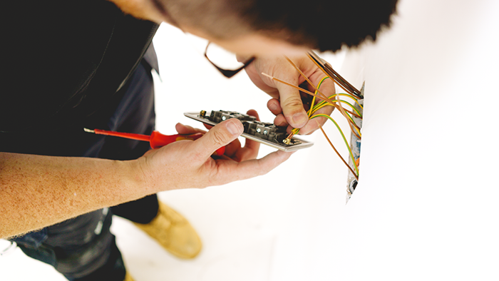 close up of electrician working on wiring on power plug