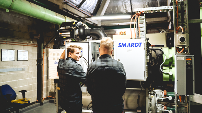 two men looking at a SMARDT air cooling unit