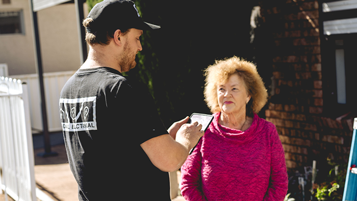 customer talking to tradie outside house