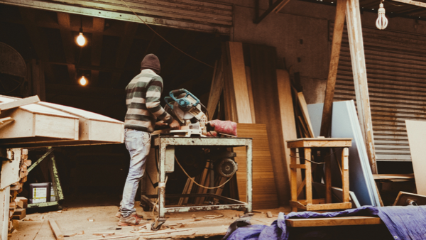 Blog_Joiner vs Carpenter_carpenter standing on a deck with a circular saw-1