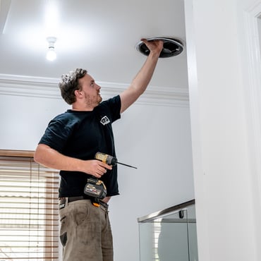 electrician installing a downlight