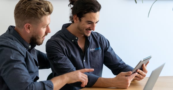 Sam and his colleague Jack working together on an ipad