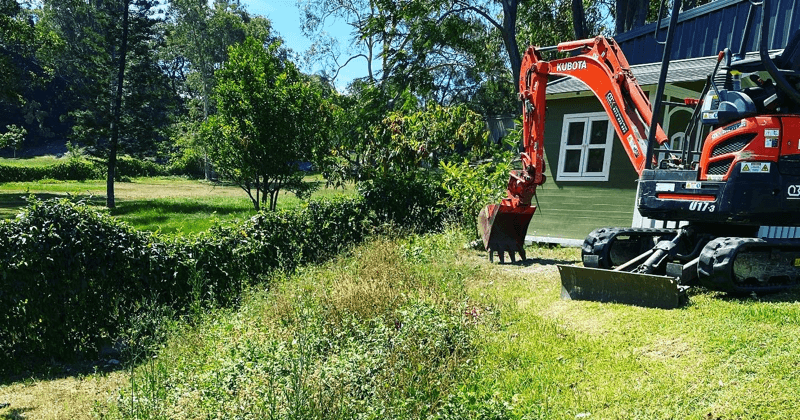 Case_Studies_GreenScapeXcavations_orange and black kubota digger on grass-1