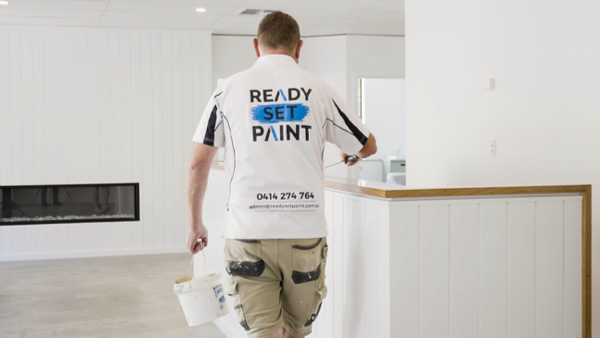 Customer Story_Ready Set Paint_painter in white shirt with a paint bucket