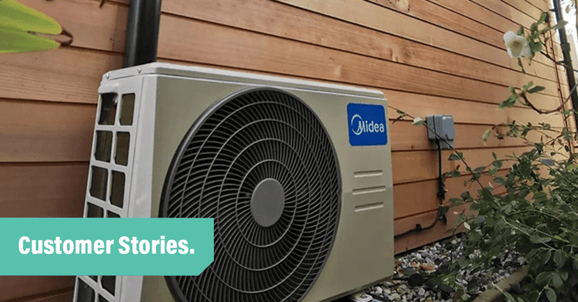 Customer-stories_Island-HVAC-Systems-UK_large-Midea-cooling-unit-by-side-of-wooden-board-house