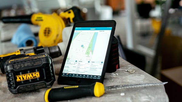 Blog-How To Grow a Carpentry or Construction Business-closeup of tablet showing map next to DeWALT drill and knife