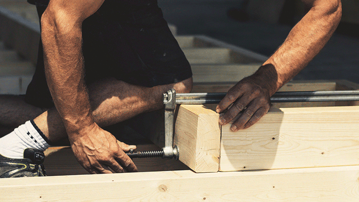 carpenter clamping timer frame together