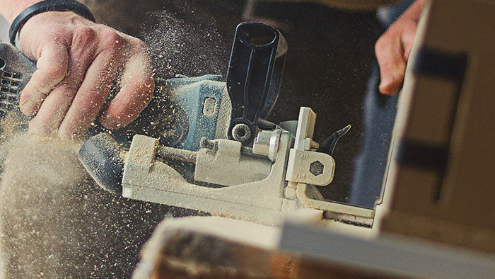 carpenter using skill saw to cut timber