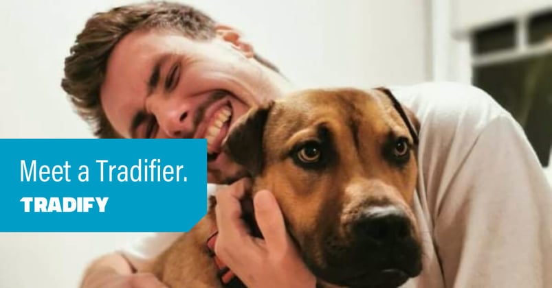 Meet a Tradifier heading with a photo of Tom hugging a dog. The dog is not amused.