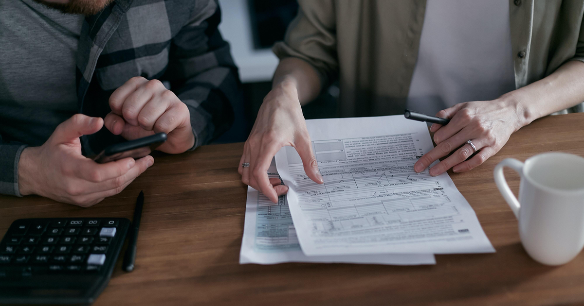 two people looking at tax paperwork