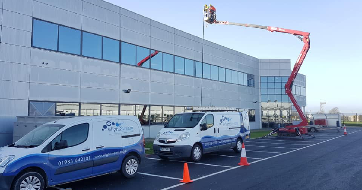 wightstream vans lined up against building