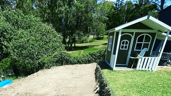 landscaping-green-and-white-outhouse-on-a-garden