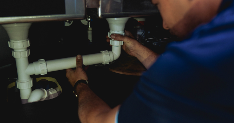 fitting a white pipe under the sink-1