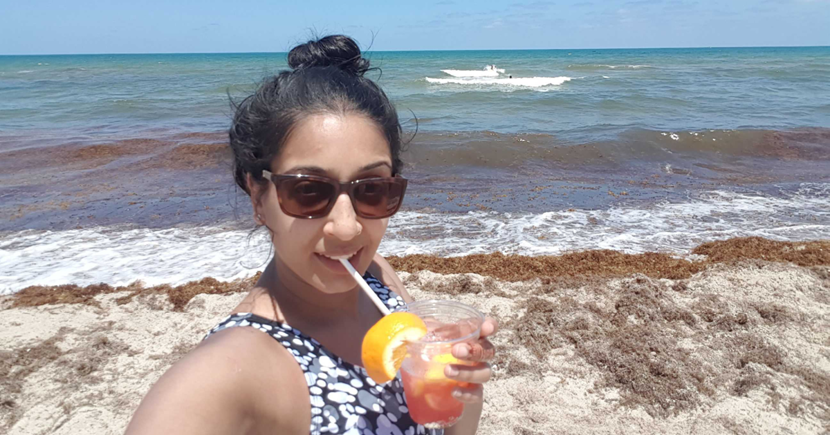 jyoti having a cocktail on the beach