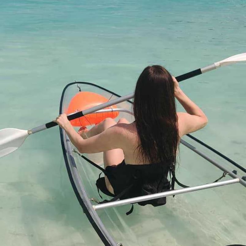 Marta rowing in a clear bottomed kayak