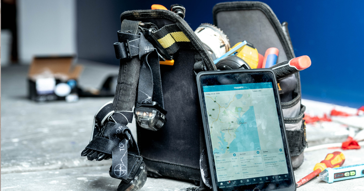 tablet and tool bag sitting on worksite floor